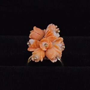 The image shows a Carved Coral ring in a bouquet arrangment